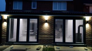 This image shows two sets of Aluminium Bi-fold doors installed on an extension in St Helens, Merseyside.