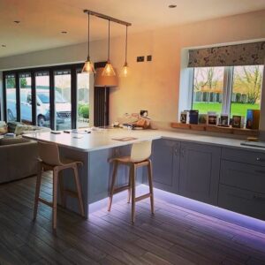 This image shows a completed kitchen renovation along with living area and bi-folds in Formby, Merseyside, by Celsius Home Improvements.