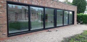 This image shows the completed installation of two sets of aluminium sliding patio doors installed by Celsius Home Improvements at a new build home in Aughton, Ormskirk.